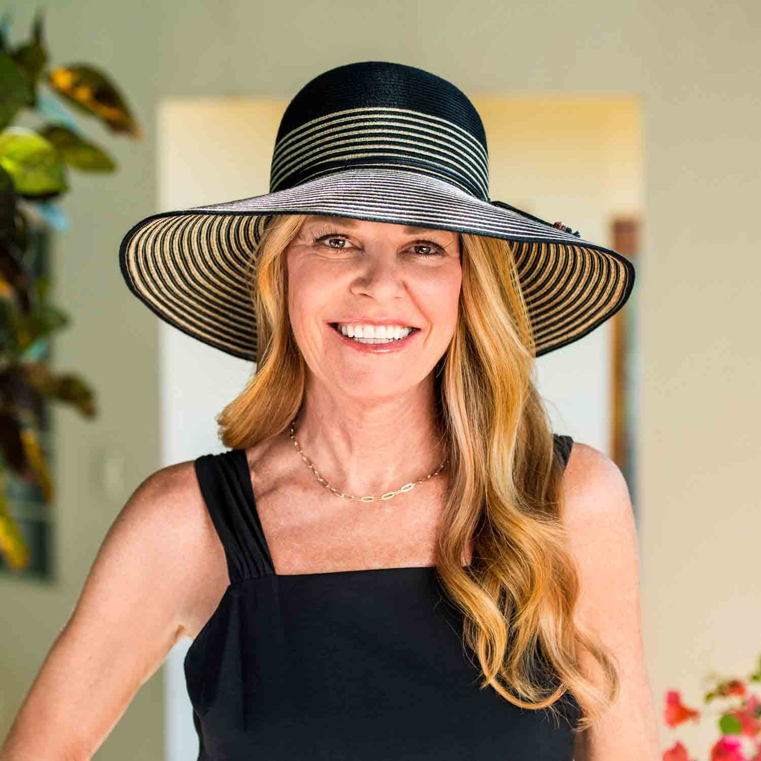 MarseilleStripedWideBrimSunHat-WallarooHatswomanwearsblackhat.jpg